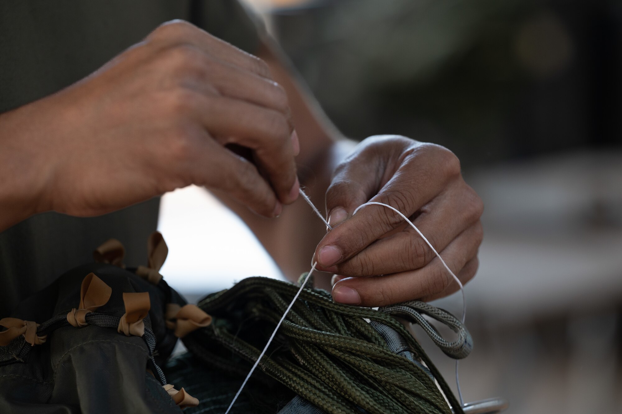 An Airman prepares a parachute for use.