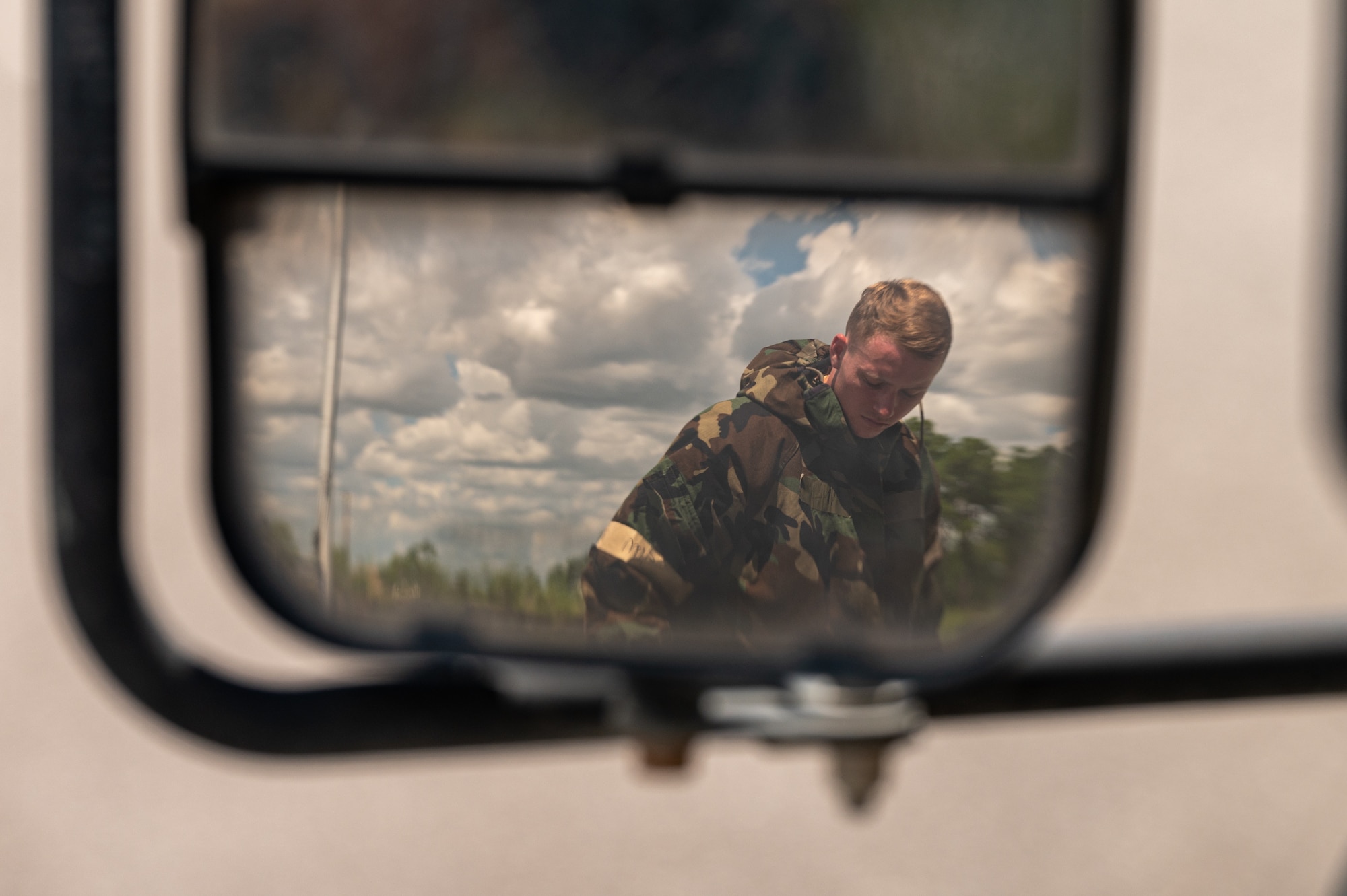 An airman dons protective gear