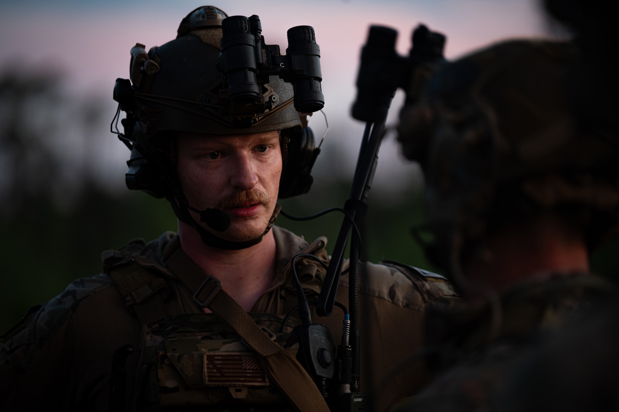 An airman talks to another airman