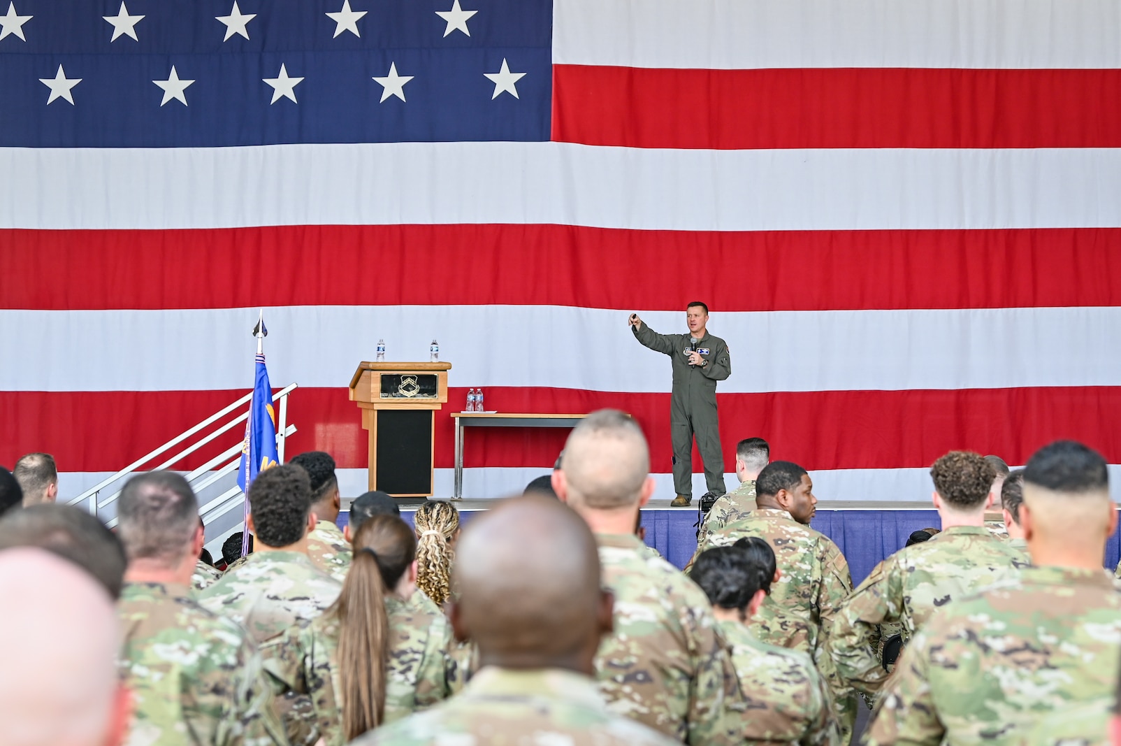 Colonel Todd “Riddler” Riddle, 944th Fighter Wing commander, addresses more than 600 Reserve Citizen Airmen during a commander’s call at Luke Air force Bae, Ariz., Sept. 7, 2024. Riddle discussed the importance of preparedness, personal resources available to Airmen, and fostering connections within the unit to ensure mission success. (U.S. Air Force photo by Senior Airman Alexis Orozco)