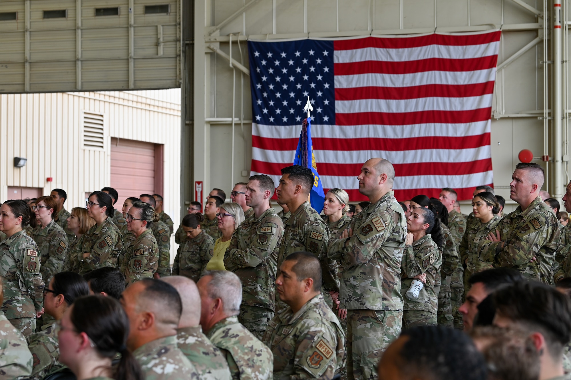 944th Fighter Wing members attentively listen during a commander’s call at Luke Air Force Base, Ariz., Sept. 7, 2024. Col. Todd “Riddler” Riddle, 944th FW commander, highlighted the importance of mission readiness and resilience while recognizing outstanding achievements within the wing. (U.S. Air Force photo by Senior Airman Alexis Orozco)
