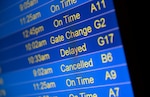 An electronic schedule of flights, showing various statuses (on time, gate changed, delayed, cancelled)