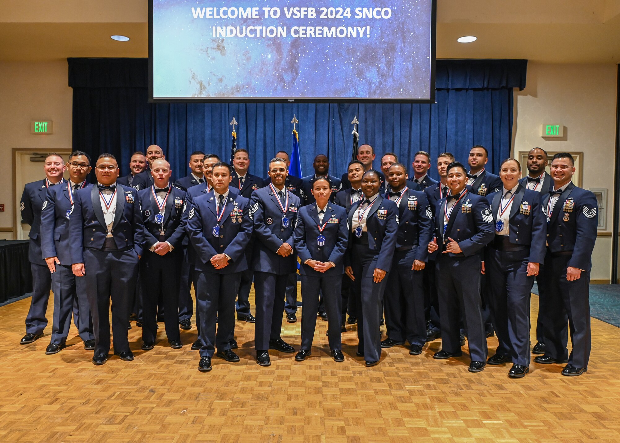 New Master Sergeant selectees pose for a photo as they celebrate during the 2024 SNCO Induction Ceremony at Vandenberg Space Force Base.