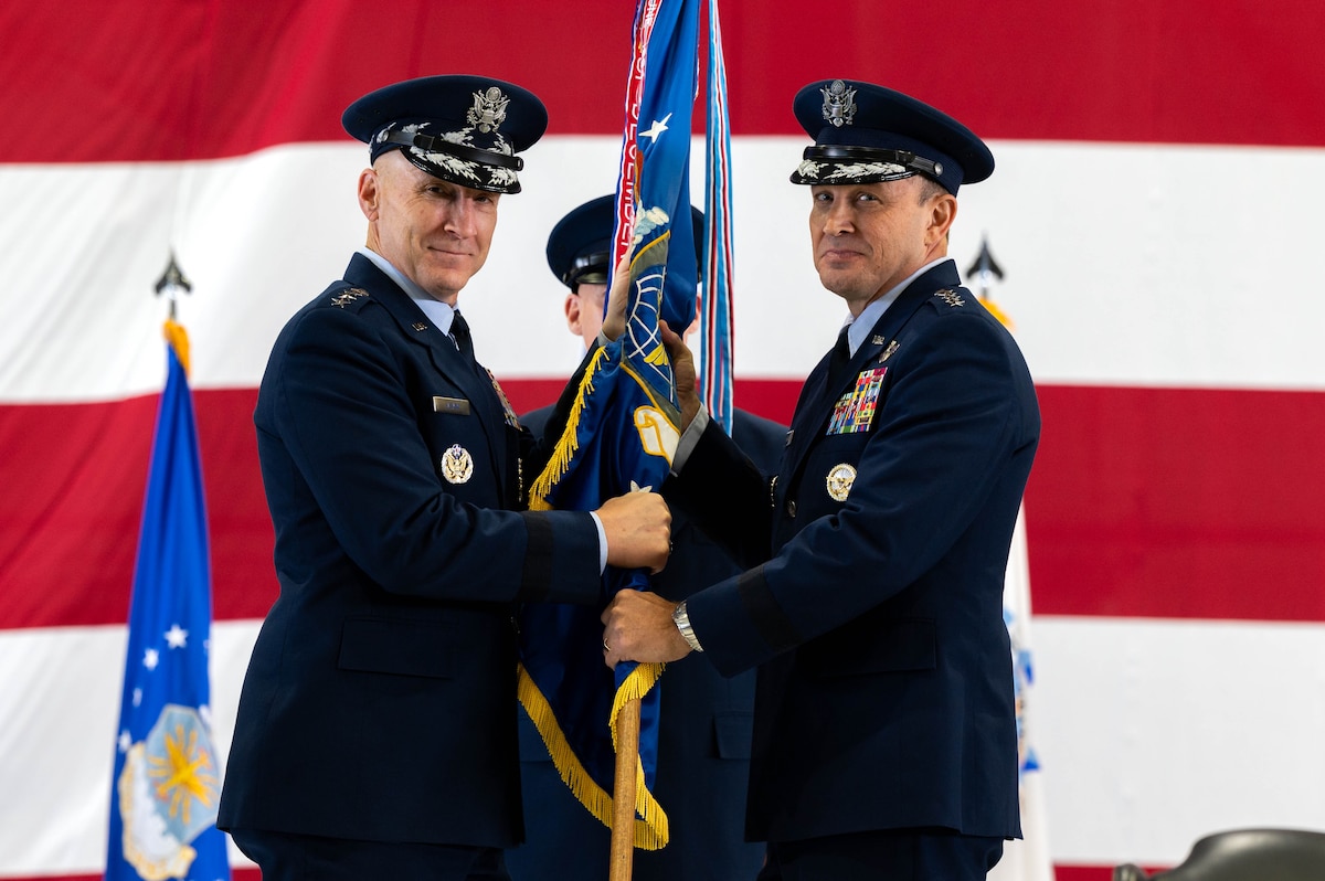 U.S. Air Force Gen. John D. Lamontagne accepts the Air Mobility Command guidon from Air Force Chief of Staff Gen. David W. Allvin during the AMC Change of Command ceremony at Scott Air Force Base, Illinois, Sept. 9, 2024. Lamontagne assumes command of AMC, leading nearly 107,000 Total Force Airmen and more than 1,100 aircraft dedicated to delivering rapid global mobility and airpower around the world.