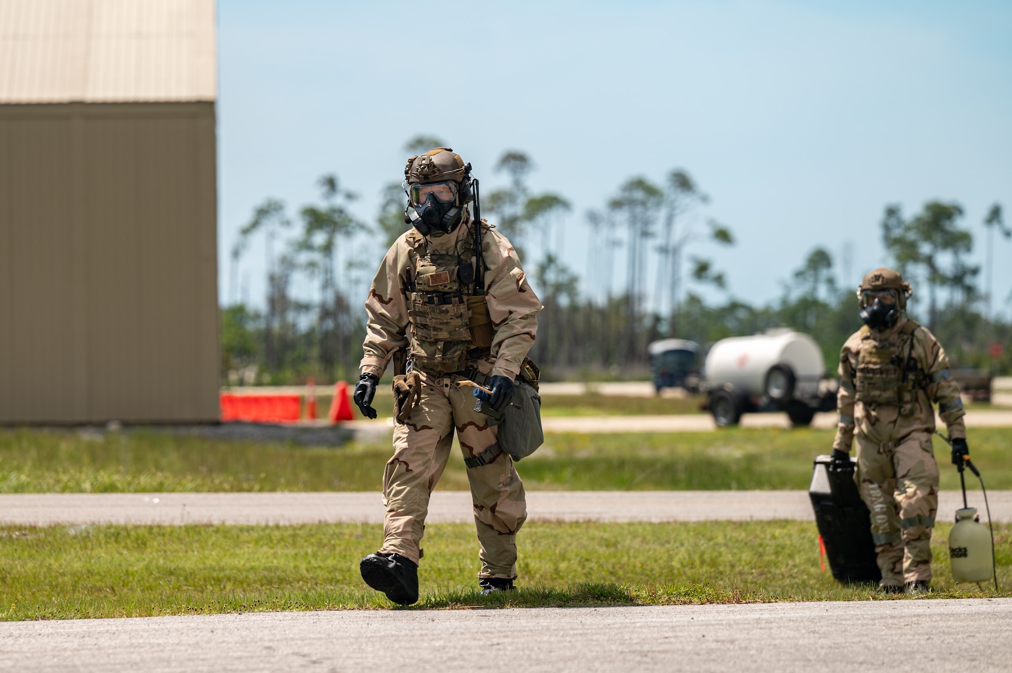 Airmen walk towards a simulated explosive