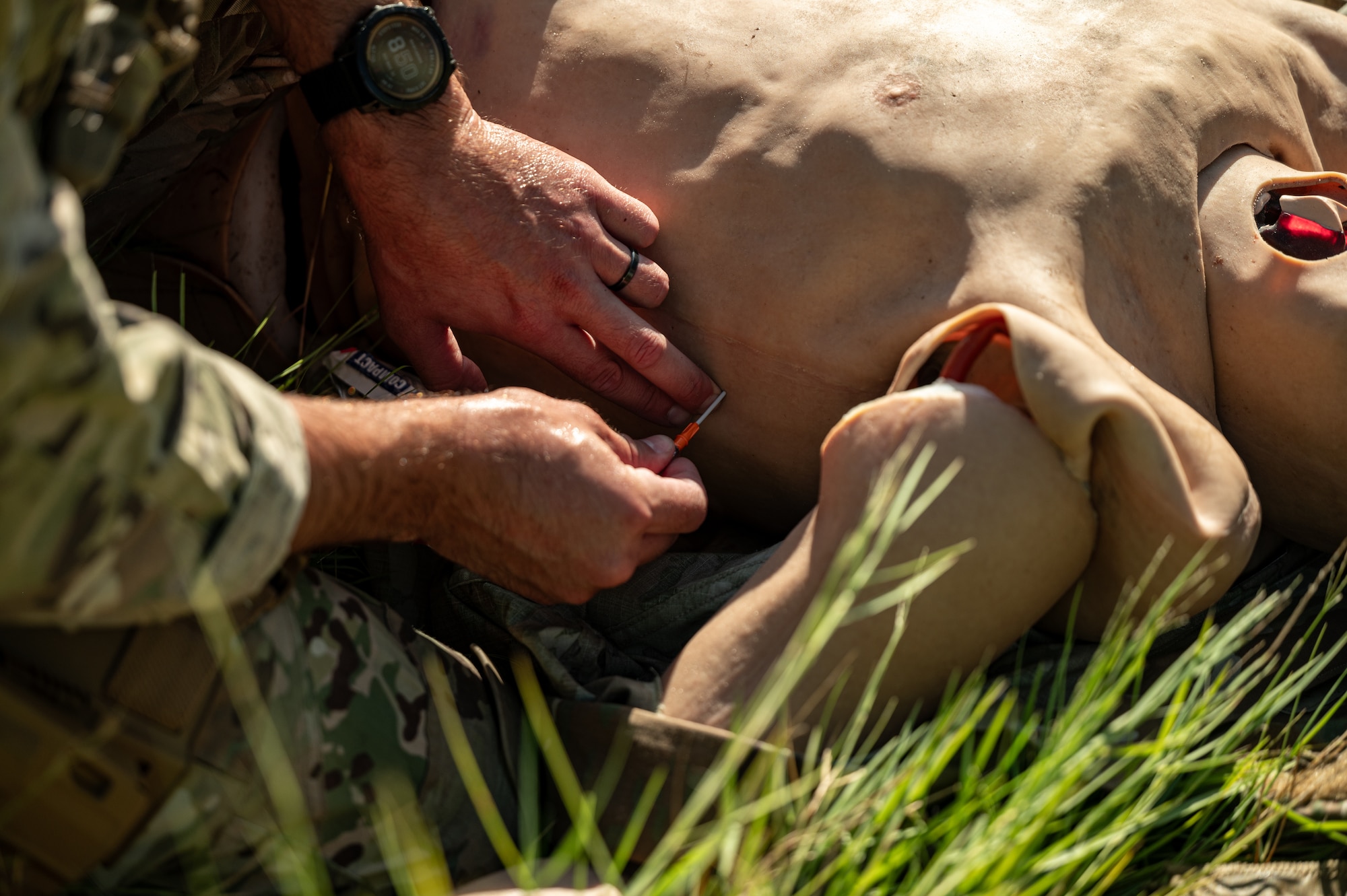 An airman administers a medical procedure