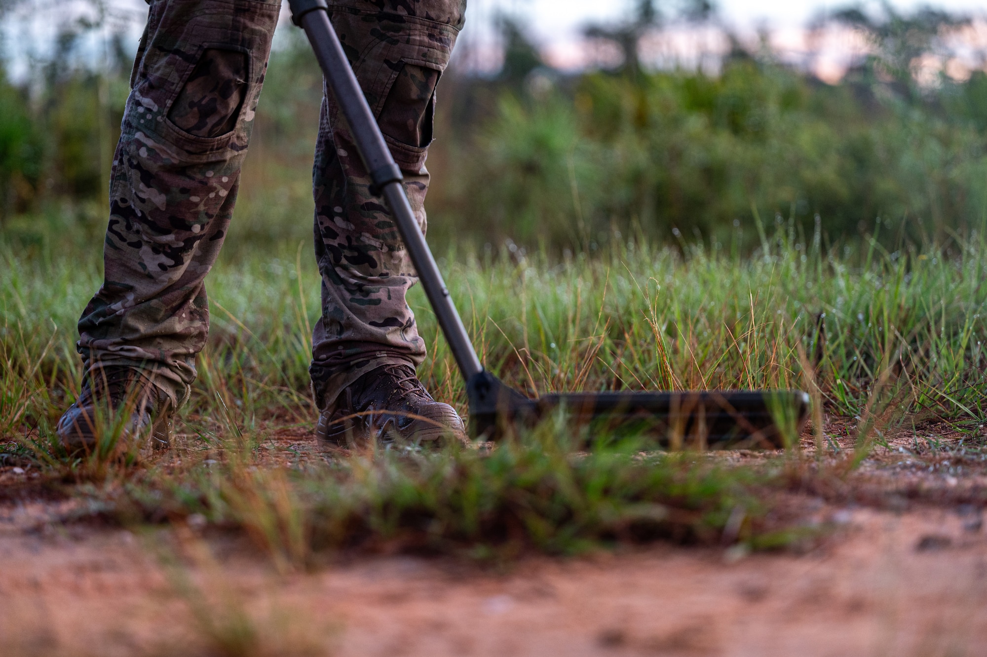 An airmen holds a metal detector