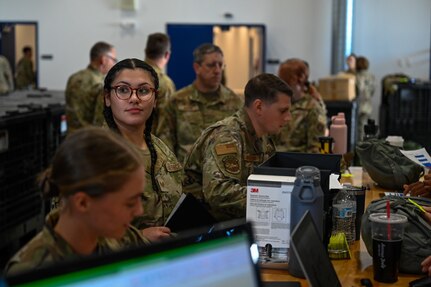 Airmen stand in a pre-deployment function line to complete administrative paperwork in preparation for an upcoming deployment, Sept. 7, 2024, at Pease Air Force Base, New Hampshire.