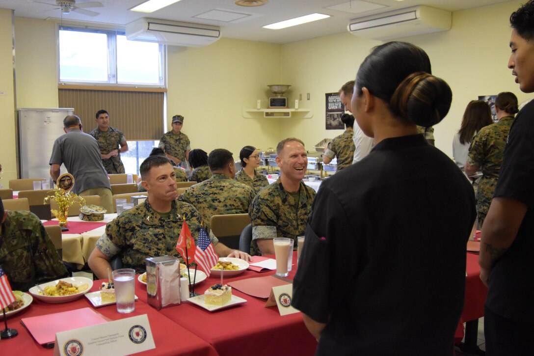 Col. Scott Welborn (left) and Sgt. Maj. Christopher Gasser, the commander and sergeant major of Combined Arms Training Center, Camp Fuji, listen as Marines explain the meal they placed in front the judges at the Marine Corps Installations Pacific’s Food Services Specialist of the Quarter competition, held at CATC Camp Fuji, August 30, 2024. (U.S. Marine Corps photo by Song Jordan)