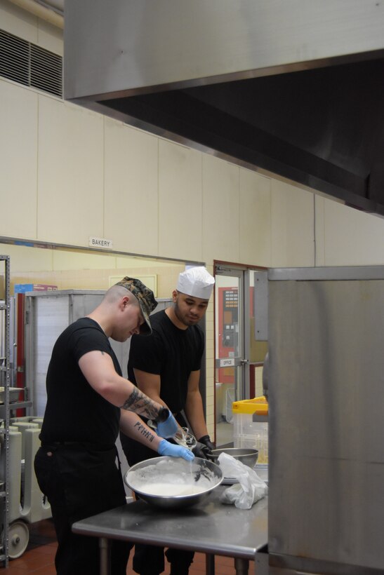 (Left to right) Sgt. Seth Sutton and Private First Class Eli Lancelot, food service specialists stationed at to Marine Corps Air Station Iwakuni, during the first day of the Marine Corps Installations Pacific’s Food Services Specialist of the Quarter competition, held at Combined Arms Training Center, Camp Fuji, August 29, 2024. (U.S. Marine Corps photo by Song Jordan)