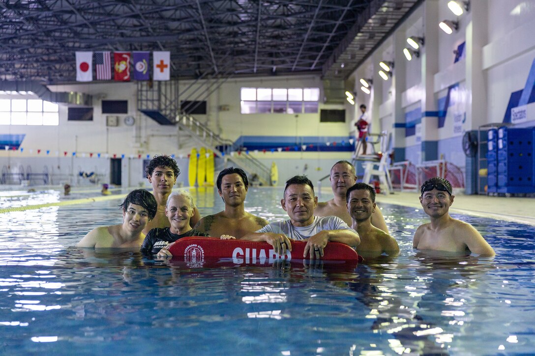 The Marine Corps Air Station Iwakuni Aquatics Team poses for a group photo in the Marine Corps Community Services’ indoor pool on Sept. 4, 2024. Ayers and the MCAS Iwakuni aquatics team provide swim clinics and master classes, and train instructors with the goal to improve service members’ survival skills and increase their water confidence. (U.S. Marine Corps photo by Sgt. Phuchung Nguyen)