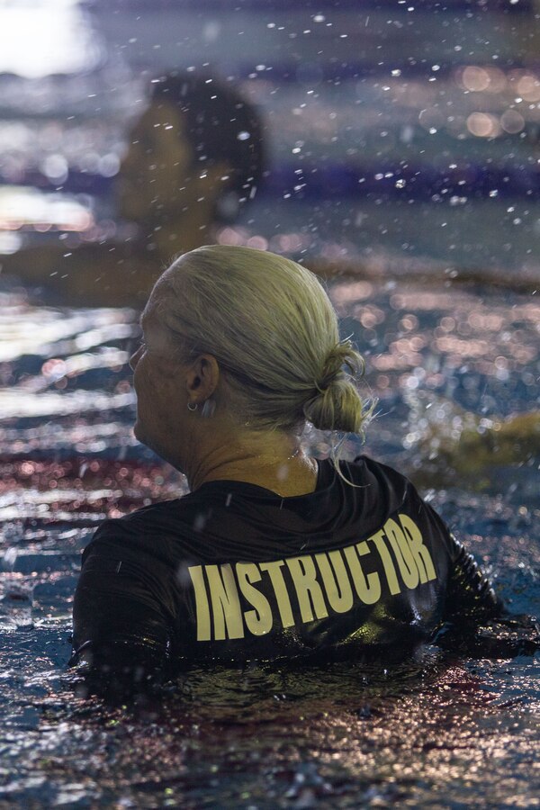 Jennifer Ayers, the Marine Corps Air Station Iwakuni aquatics director and a South Carolina native, watches as swim instructors perform drills during an instructor training in the Marine Corps Community Services’ indoor pool on Sept. 4, 2024. Ayers and the MCAS Iwakuni aquatics team provide swim clinics and master classes, and train instructors with the goal to improve service members’ survival skills and increase their water confidence. (U.S. Marine Corps photo by Sgt. Phuchung Nguyen)