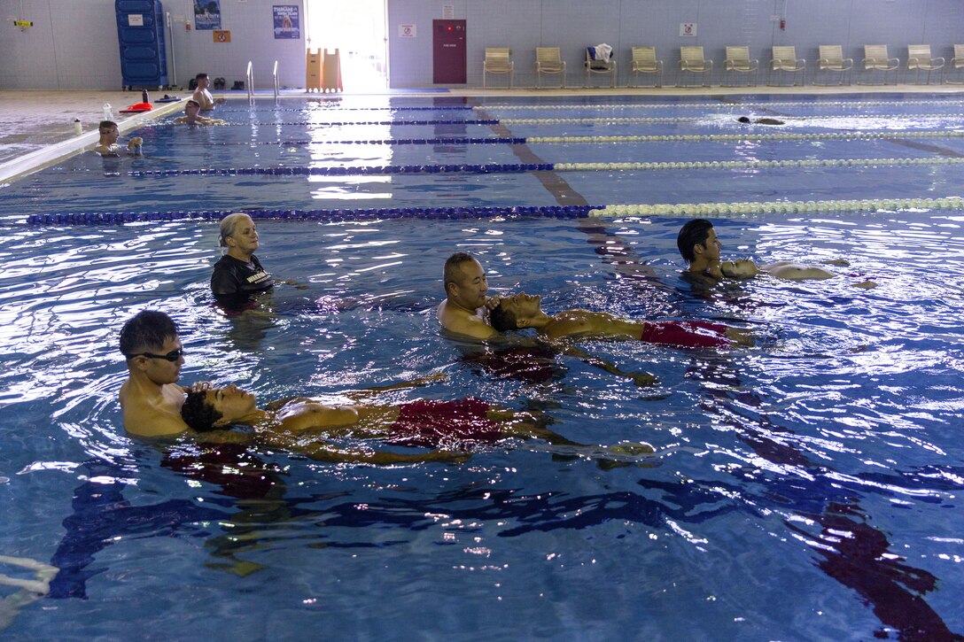Jennifer Ayers, the Marine Corps Air Station Iwakuni aquatics director and a South Carolina native, watches as swim instructors perform drills during an instructor training in the Marine Corps Community Services’ indoor pool on Sept. 4, 2024. Ayers and the MCAS Iwakuni aquatics team provide swim clinics and master classes, and train instructors with the goal to improve service members’ survival skills and increase their water confidence. (U.S. Marine Corps photo by Sgt. Phuchung Nguyen)