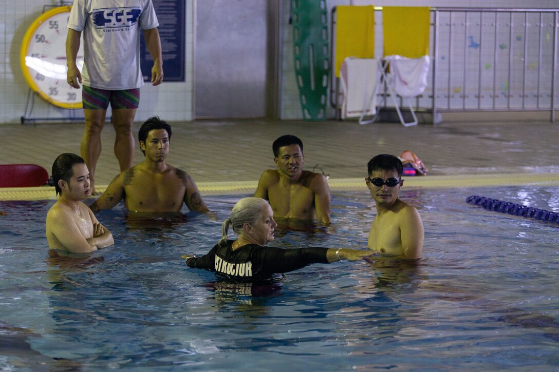 Jennifer Ayers, the Marine Corps Air Station Iwakuni aquatics director and a South Carolina native, guides her swim instructors during an instructor training in the Marine Corps Community Services’ indoor pool on Sept. 4, 2024. Ayers and the MCAS Iwakuni aquatics team provide swim clinics and master classes, and train instructors with the goal to improve service members’ survival skills and increase their water confidence. (U.S. Marine Corps photo by Sgt. Phuchung Nguyen)