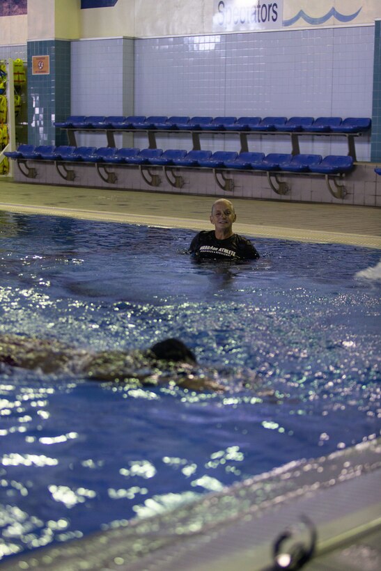 Jennifer Ayers, the Marine Corps Air Station Iwakuni aquatics director and a South Carolina native, watches as a swim instructor performs a drill in the Marine Corps Community Services’ indoor pool on Sept. 4, 2024. Ayers and the MCAS Iwakuni aquatics team provide swim clinics and master classes, and train instructors with the goal to improve service members’ survival skills and increase their water confidence. (U.S. Marine Corps photo by Sgt. Phuchung Nguyen)