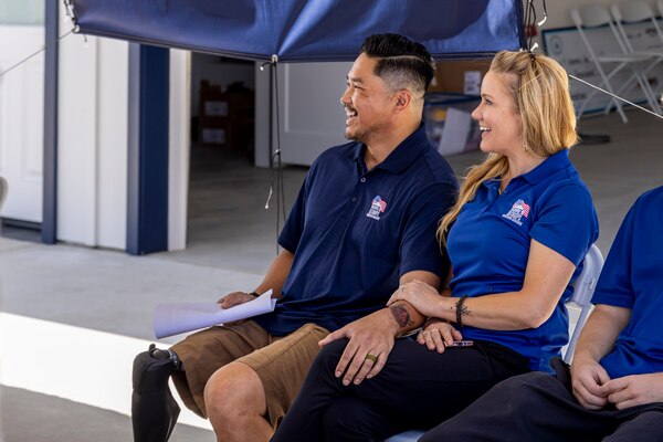 ESCONDIDO, Calif. -- Naval Medical Center San Diego’s lead prosthetist, Nathaniel “Randell” Leoncio (L) is presented with a custom home in Escondido, Calif., from the Homes For Our Troops non-profit organization, Aug. 24, 2024.  Seated with his wife, Abreail Leoncio, they are recipients of the goodwill on the part of many committed to improving the lives of Veterans.  The mission of NMCSD is to prepare service members to deploy in support of operational forces, deliver high quality health care services, and shape the future of military medicine through education, training, and research. NMCSD employs more than 5,000 active-duty military personnel, civilians and contractors in southern California to provide patients with world-class care. Anchored in Excellence, Committed to Health!