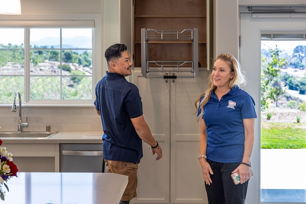 ESCONDIDO, Calif. -- Naval Medical Center San Diego’s lead prosthetist, Nathaniel “Randell” Leoncio (L) is presented with a custom home in Escondido, Calif., from the Homes For Our Troops non-profit organization, Aug. 24, 2024.  Accompanied by his wife, Abreail Leoncio, the Leoncio's get acquainted with their new kitchen.  The mission of NMCSD is to prepare service members to deploy in support of operational forces, deliver high quality health care services, and shape the future of military medicine through education, training, and research. NMCSD employs more than 5,000 active-duty military personnel, civilians and contractors in southern California to provide patients with world-class care. Anchored in Excellence, Committed to Health!