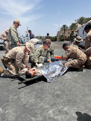 AQABA, JORDAN (May 15, 2024) – Tactical Casualty Combat Care participants secure patients for transport at the point of injury during exercise Eager Lion 2024, May 15, 2024. Eager Lion is designed to exchange military expertise, improve interoperability among partner nations, and considered the capstone of a broader U.S. military relationship with the Jordanian Armed Forces. (U.S. Navy photo by Lt. Fremmy Cuadra/Released)