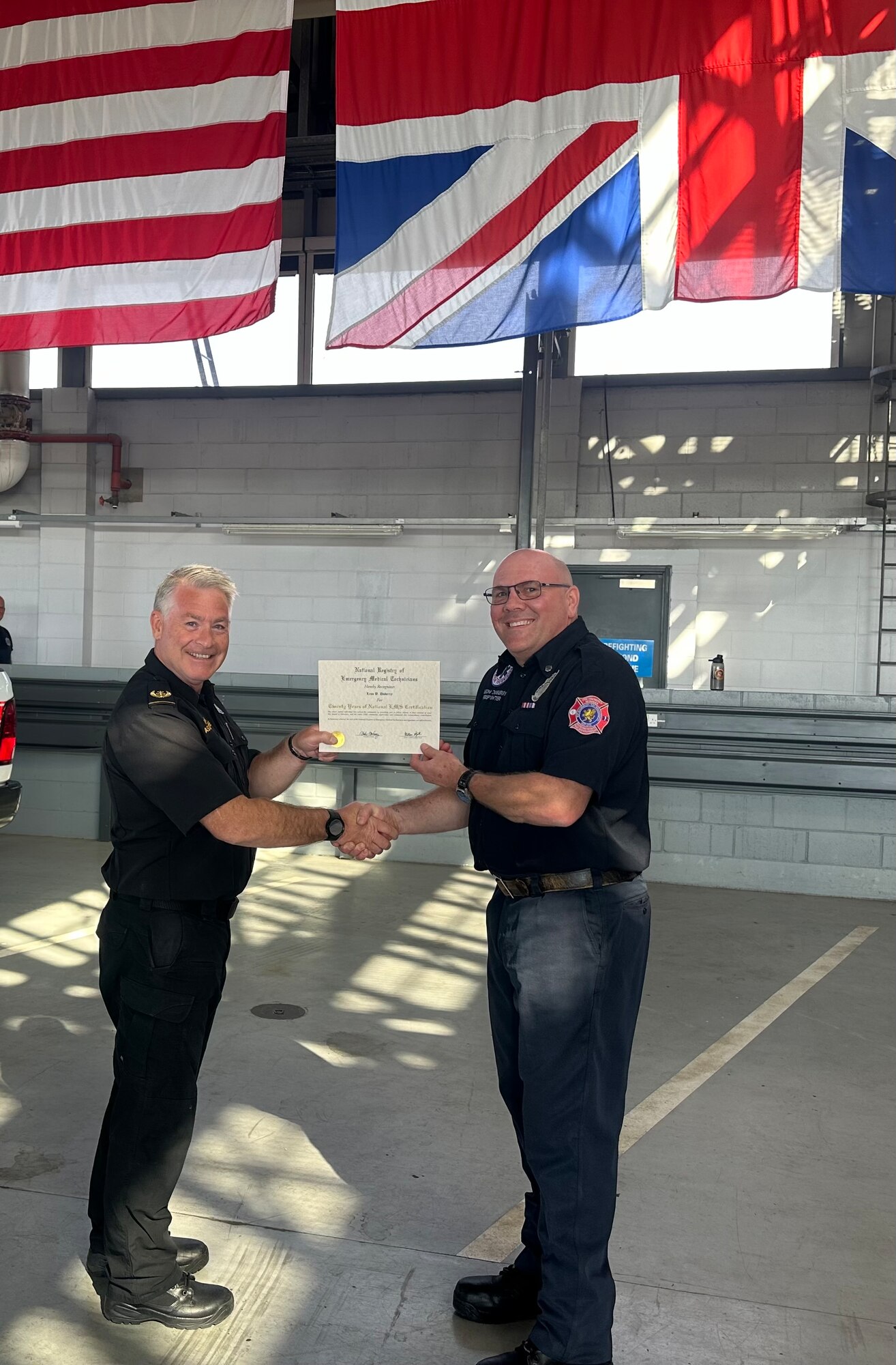 Phil Batten, 423rd assistant CES/CEF chief of operations hands Leon B. Duberry, 423rd RAF Alconbury/Molesworth firefighter/EMT a 20 years of EMT service certificate.