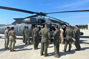 Airmen from the 106th Rescue Wing look at the 106th ’s first HH-60W Jolly Green II combat search and rescue helicopter to arrive at Francis S. Gabreski Air National Guard Base, Westhampton Beach, N.Y., June 20, 2024. The helicopter was flown by the 41st Rescue Squadron at Moody Air Force Base, Georgia, and marks the beginning of a new era as the 106th officially begins its transition from the HH-60G Pave Hawk to the HH-60W model. (U.S. Air National Guard photo by Senior Airman Sarah McKernan)