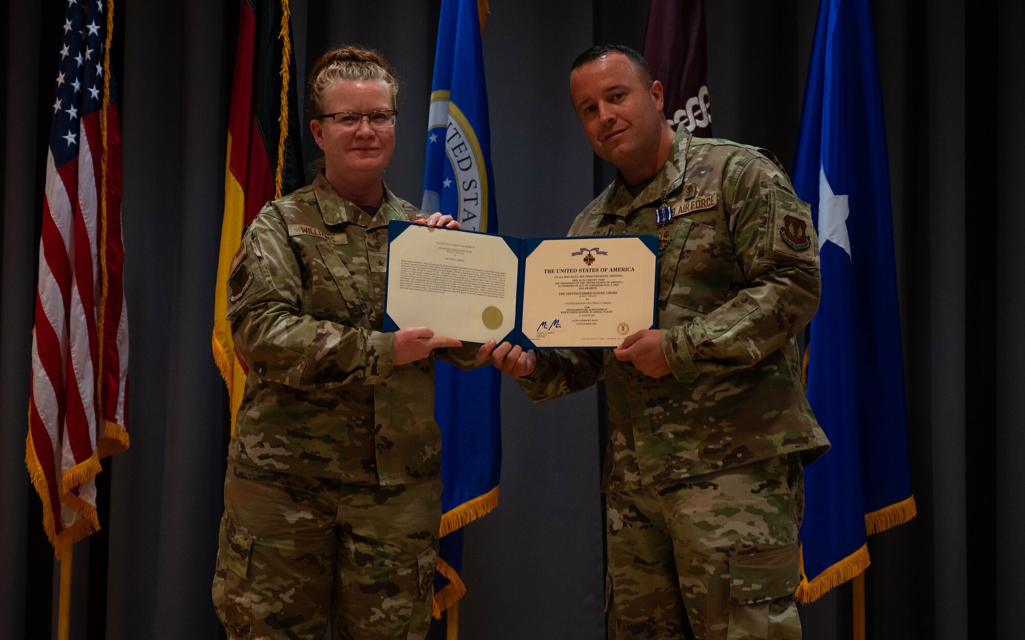 U.S. Air Force Master Sgt. Matthew Parker, 86th Medical Squadron surgical services superintendent, receives the Distinguished Flying Cross from U.S. Air Force Brig. Gen. Adrienne L. Williams, 86th Airlift Wing commander, at Landstuhl Regional Medical Center, Germany, Sept. 6, 2024. Parker distinguished himself as a critical care air transport team cardiopulmonary technician during Operation Freedom’s Sentinel, acting in response to a mass casualty evacuation operation at Hamid Karzai International Airport, Afghanistan on August 27, 2021. (U.S. Air Force Photo by Senior Airman Jared Lovett)