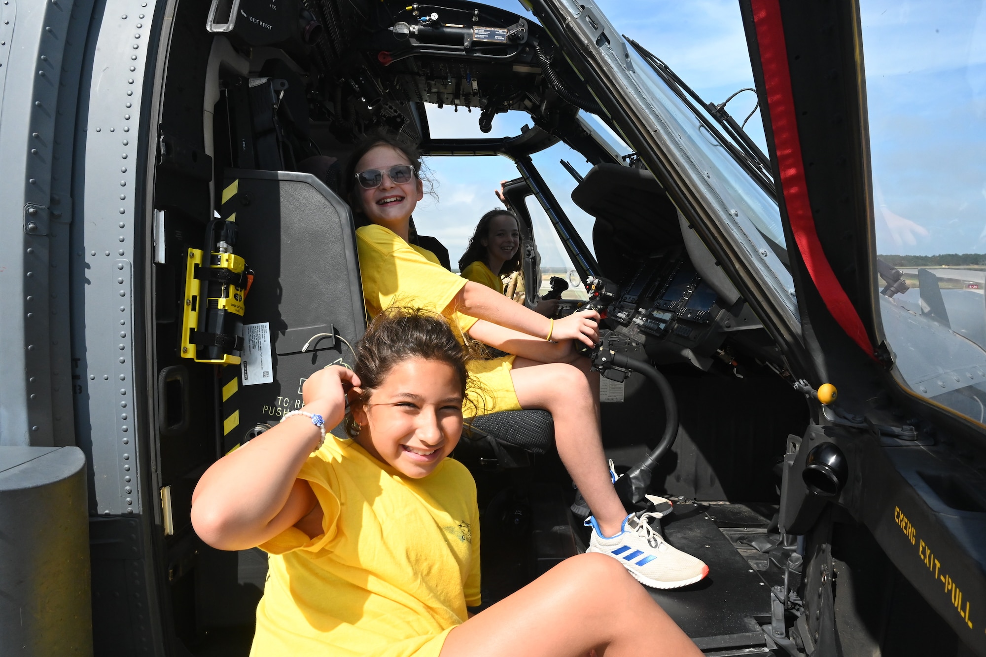 Campers, children of Airmen from the 106th Rescue Wing, sit inside an HH-60W Jolly Green II assigned to the 106th during a base tour as part of the 18th Annual Galaxy Camp at Francis S. Gabreski Air National Guard Base, Westhampton Beach, N.Y. The 5-day camp included STEM activities, leadership training, base tours, and interactions with Airmen, equipment, vehicles, and aircraft, focusing on safety, teamwork, and communication. (U.S. Air National Guard photos by Staff Sgt. Kevin J. Donaldson)