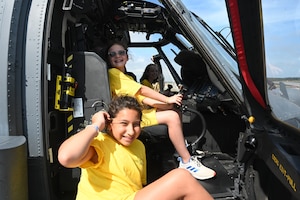 Campers, children of Airmen from the 106th Rescue Wing, sit inside an HH-60W Jolly Green II assigned to the 106th during a base tour as part of the 18th Annual Galaxy Camp at Francis S. Gabreski Air National Guard Base, Westhampton Beach, N.Y. The 5-day camp included STEM activities, leadership training, base tours, and interactions with Airmen, equipment, vehicles, and aircraft, focusing on safety, teamwork, and communication. (U.S. Air National Guard photos by Staff Sgt. Kevin J. Donaldson)