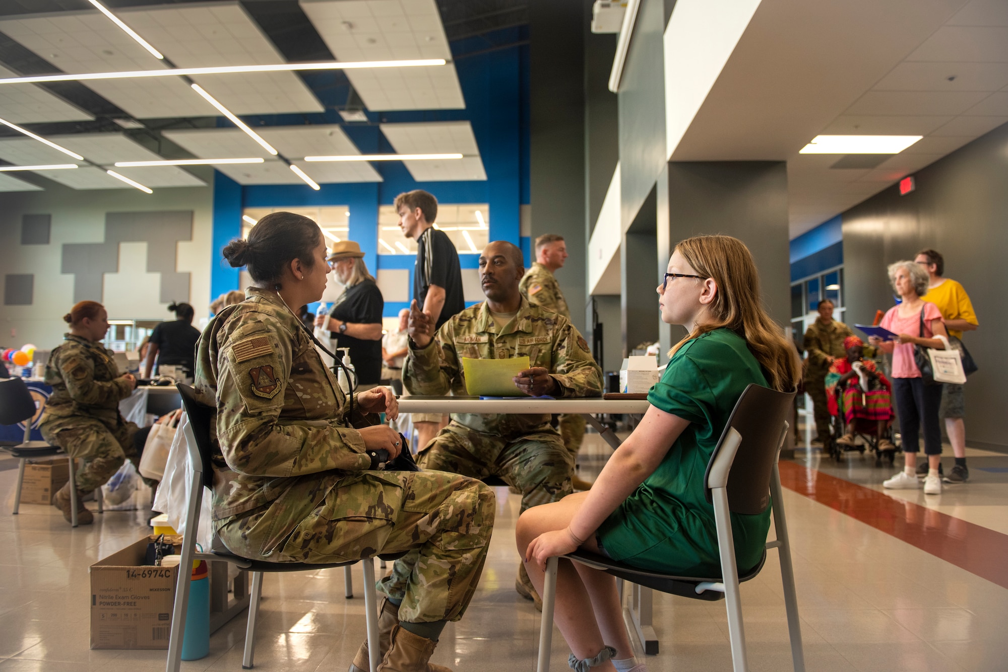 Child listen to two military medics talk
