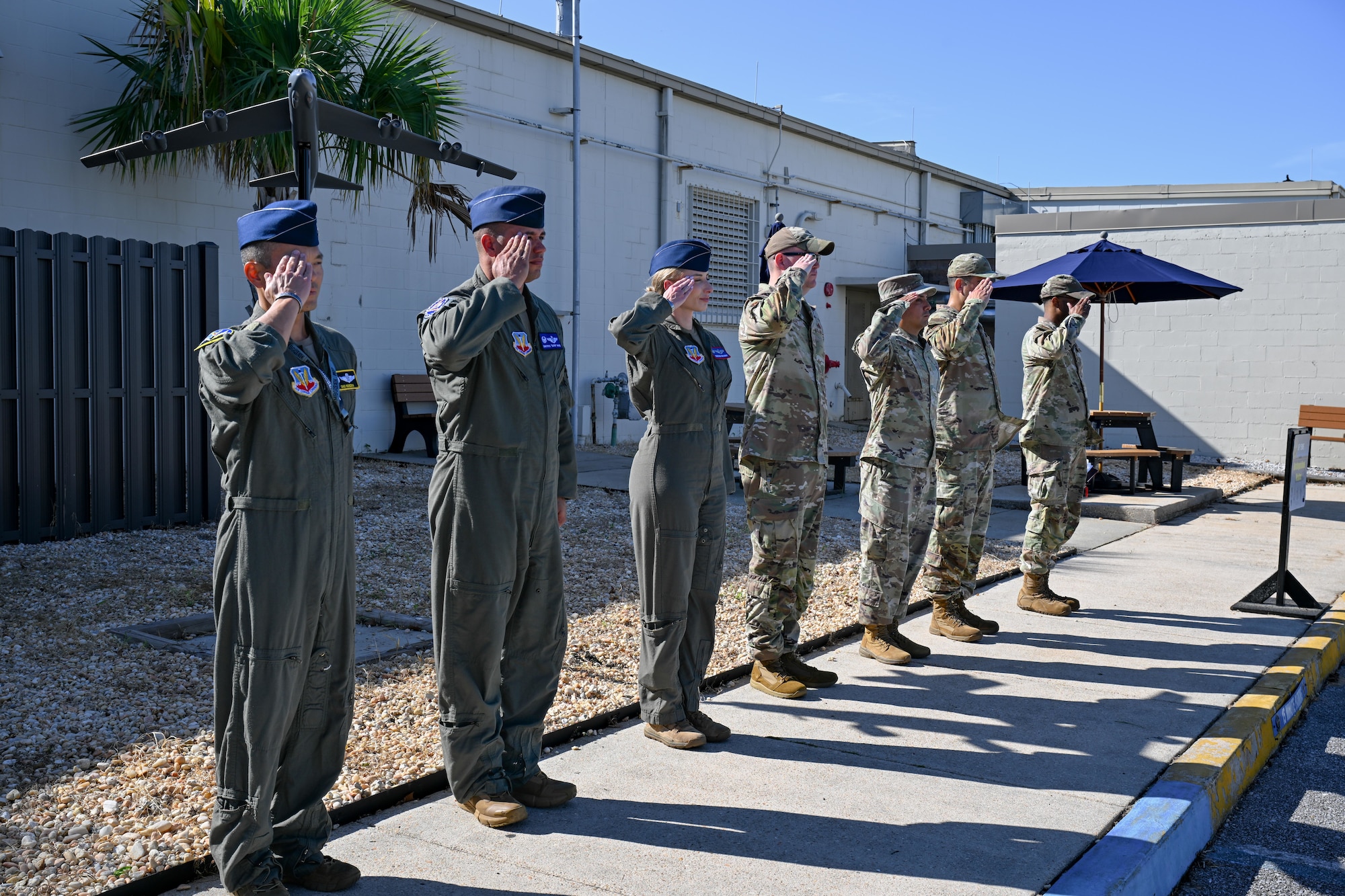 Members of the 350th Spectrum Warfare Wing salute as U.S. Air Force Maj. Gen. Christopher Niemi, commander of the U.S. Air Force Warfare Center, arrives for a portion of the wing tour at Eglin Air Force Base, Florida, Aug. 29, 2024. Niemi visited the 350th SWW to learn more about its mission to provide electromagnetic spectrum warfare capabilities to joint force and coalition partners. (U.S. Air Force photo by Senior Airman Anna Smith)