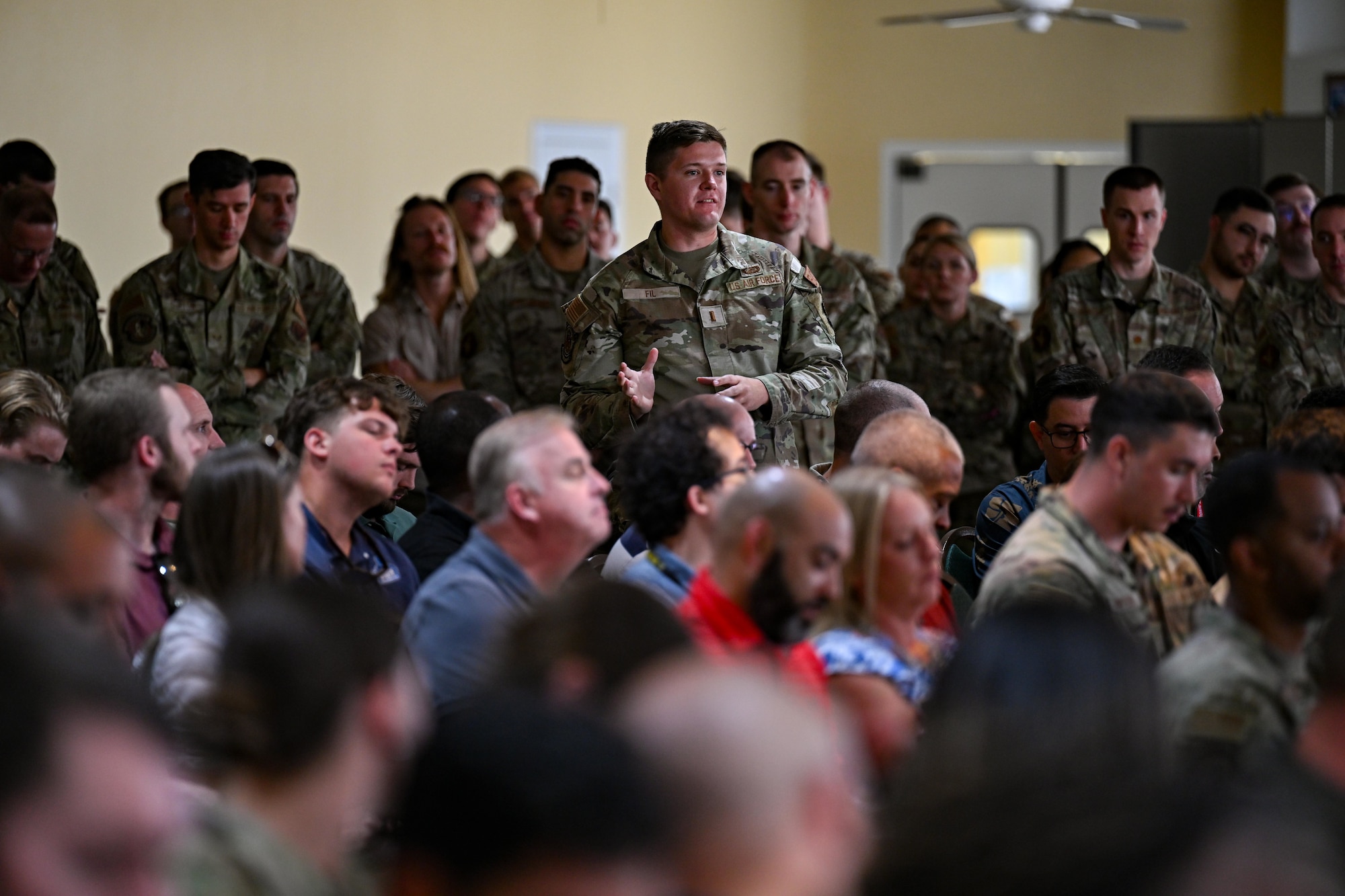 A member assigned to Eglin Air Force Base asks a question during an all call hosted by U.S. Air Force Maj. Gen. Christopher Niemi, commander of the U.S. Air Force Warfare Center, at Eglin Air Force Base, Florida, Aug. 29, 2024. Niemi hosted the all call to discuss the threat environment facing the Air Force and the importance of readiness of all Airmen. (U.S. Air Force photo by Anna Smith)