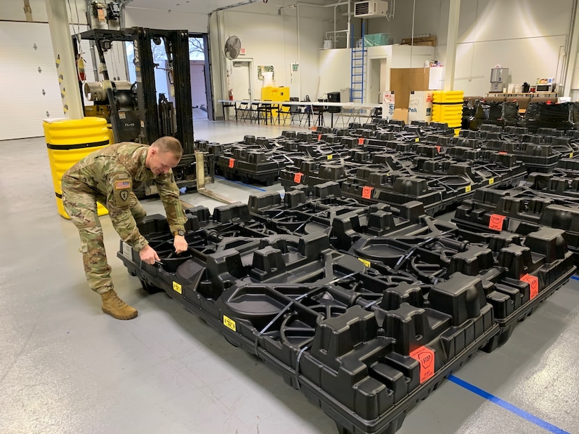 Staff Sgt. Zachary Casey helps unload the plastic crates containing the new Army Combat Fitness Test (ACFT) equipment onto the USPFO warehouse floor Dec. 11, 2019. (Courtesy photo)