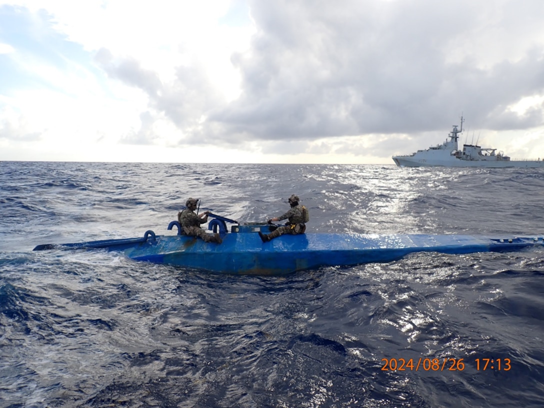 Crew members form U.S. Coast Guard Tactical Law Enforcement Detachment (LEDET) 111 and British Royal Navy team embarked aboard HMS Trent (P244) interdicts a semi-submersible drug smuggling vessel in the international waters of the Caribbean Sea, Aug. 26, 2024. Three suspected smugglers and 1,239 pounds of illegal narcotics from this interdiction were transferred to federal custody for prosecution by the U.S. Department of Justice. (Courtesy image from United Kingdom Royal Navy)