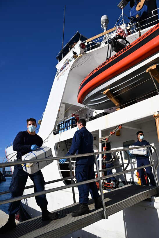 Crew members from Coast Guard Cutter Diligence (WMEC 616) carries bales of cocaine worth an estimated $54 million during a drug offload at Port Everglades, Florida, Sept. 9, 2024. Coast Guard crews worked alongside interagency and international partners to seize the illegal narcotics in the international waters of the Caribbean Sea during three separate interdictions. (U.S. Coast Guard photo by Petty Officer 3rd Class Eric Rodriguez)