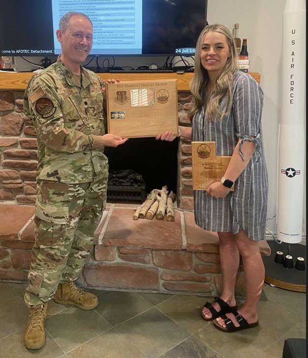 Lt. Col. Adam Rector presents Hannah Hadley an award named after her for saving the life of a child.