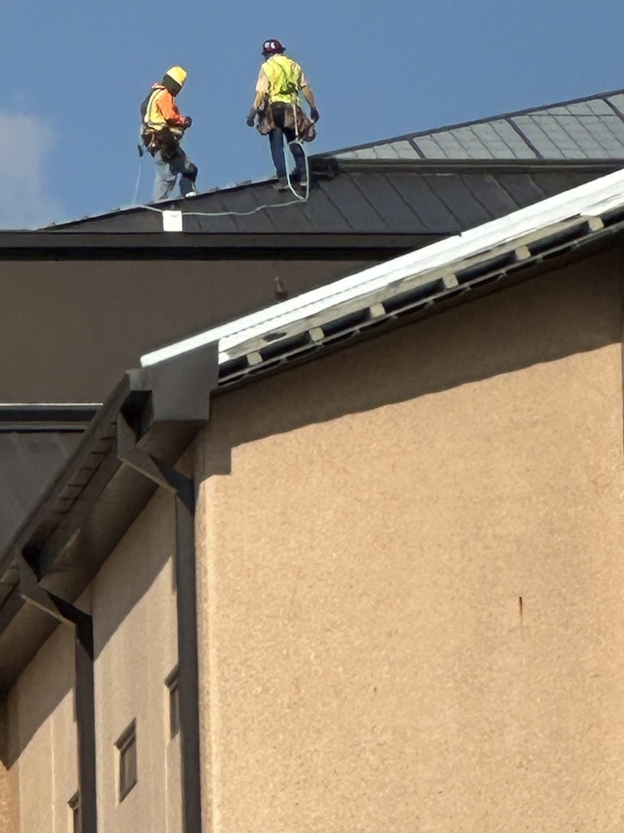 workers on the roof of the BMT building.