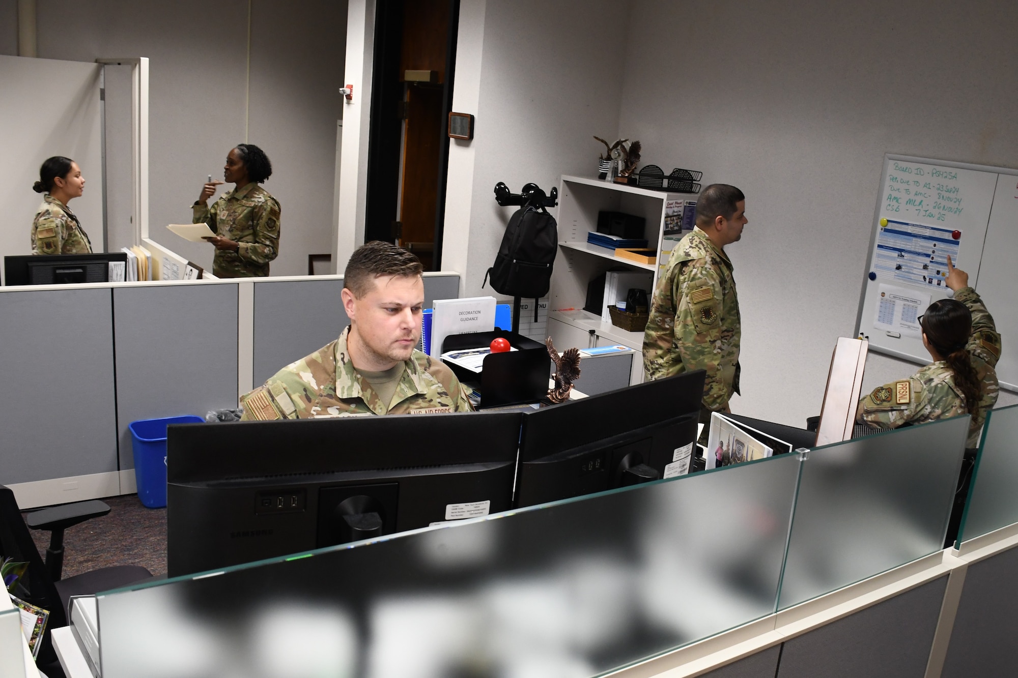 Tech Sgt. Ian Tracy, foreground, an administrative specialist in the Air Force Expeditionary Center’s A1 directorate, reviews official decorations for the center’s Airmen at Joint Base McGuire-Dix-Lakehurst, New Jersey, Sept. 9, 2024. Tracy, who oversees more than 70 commander support staff and enterprise programs, was name the Expeditionary Center Noncommissioned Officer of the Quarter and was a member of the Team of the Quarter for the period of April-June 2024. (U.S. Air Force photo by Shawn J. Jones)