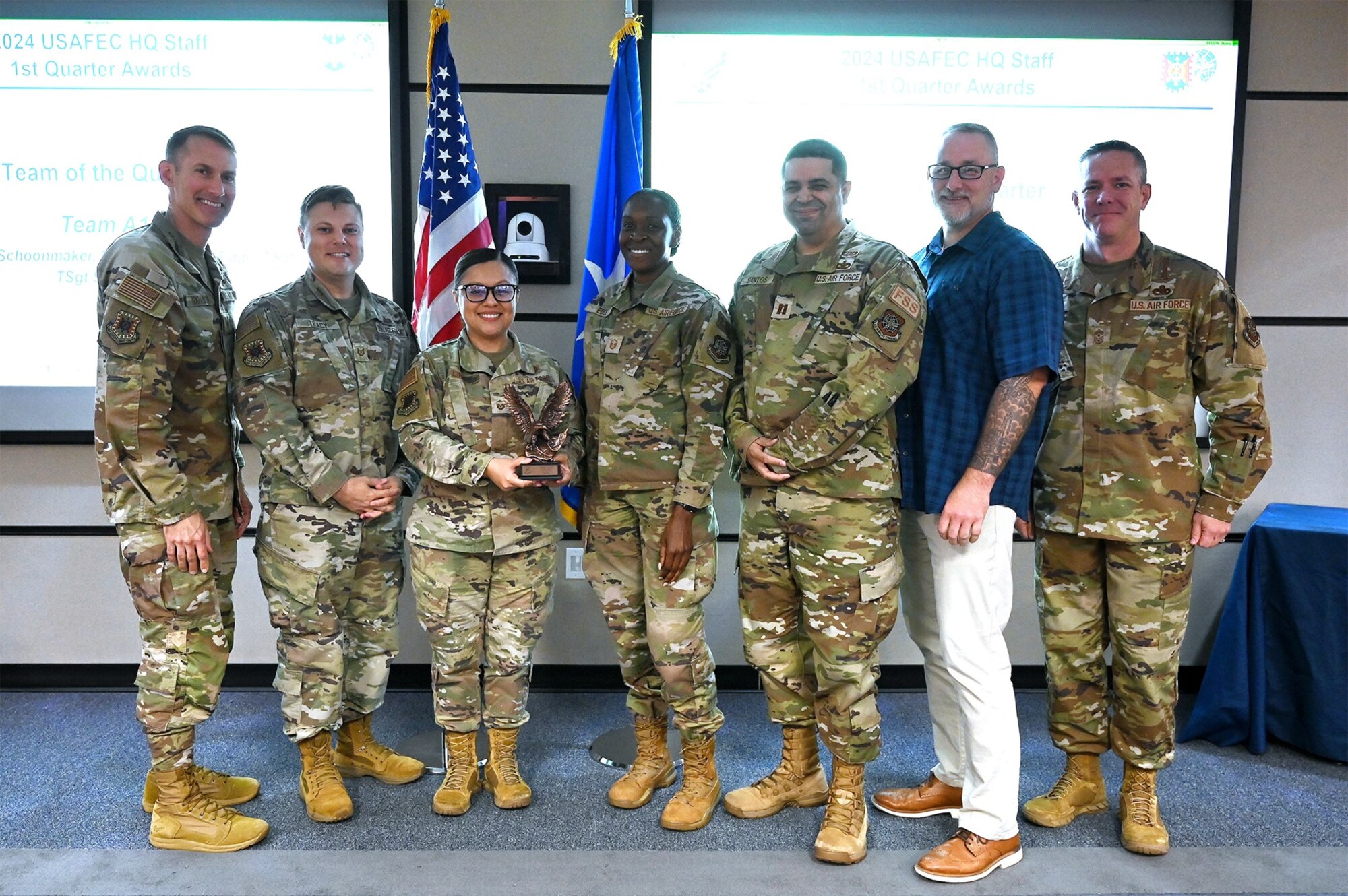 The A1 Directorate at the Air Force Expeditionary Center was presented with the Team of the Quarter award by Brig. Gen. Stephen Snelson, the center’s commander, at Joint Base McGuire-Dix-Lakehurst, New Jersey, on Aug. 21, 2024. Pictured from left to right are Snelson, Tech. Sgt. Ian Tracy, Master Sgt. Cindy Lino, Master Sgt. Imelda Edge, Capt. Erik Santos, David Schoonmaker, and Chief Master Sgt. Dennis Fuselier, the center’s command chief. Tech. Sgt. Crystal Shepherd is also part of the A1 team but was unavailable for the photo. (U.S. Air Force photo by Shawn J. Jones)