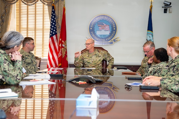 240909-N-MT837-1006 Naval Medical Center Portsmouth (NMCP) welcomed U.S. Army Brigadier General Lance Raney, Medical Readiness Command (MRC) East commanding general, Sept. 9.  Raney (center) speaks with Capt. Brian L. Feldman, NMCP director/Navy Medicine Readiness and Training Command Portsmouth commander, and others in the NMCP commanding officer’s conference room.