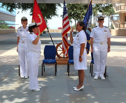 Ensign Grace Joan Reveles is administered the oath of office by Lt. Cmdr. Nancy Helfrich during Reveles’ commissioning ceremony held Sept. 6, 2024, on the Naval Hospital Camp Pendleton Medal of Honor Promenade. Having obtained both her associate degree and bachelor’s degree in nursing while serving on active duty as a corpsman, Reveles was commissioned into the Navy Nurse Corps via the Direct Accession Program.