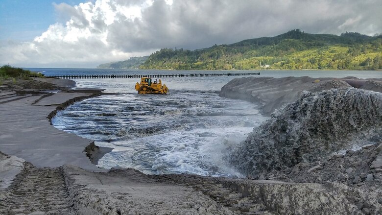 Dredged material is graded following shoreline placement on Pillar Rock Island in the lower Columbia. Shoreline placement assists in habitat creation and allows the Corps to keep clean sand in the Lower Columbia River system but outside of the Federal Navigation Channel.