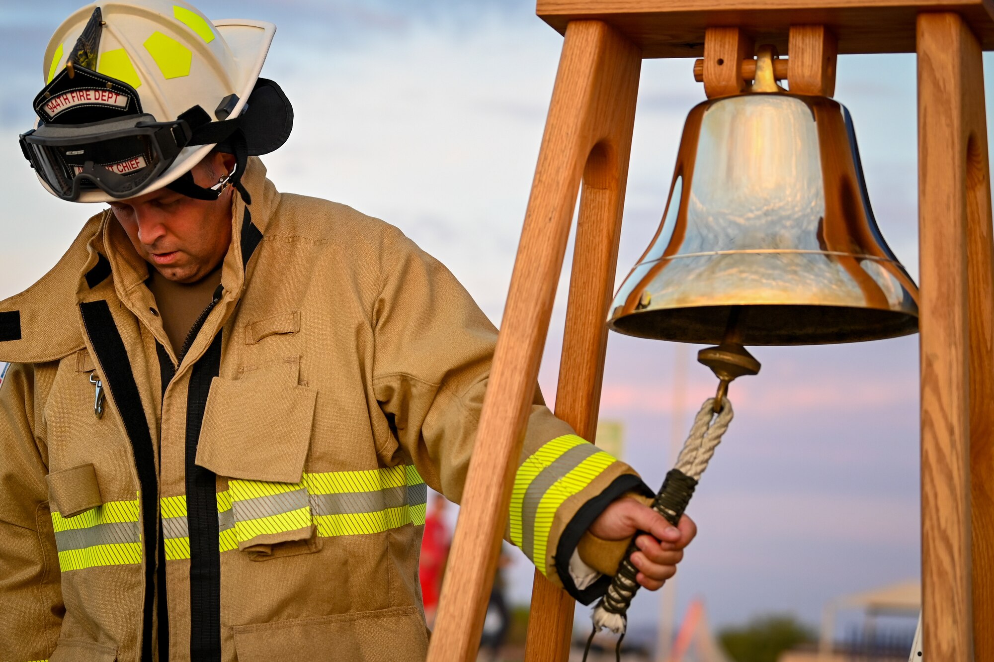 Master Sgt. Michael Brick, assistant fire chief of health and safety for the 944th Fighter Wing, rings a bell in honor of fallen firefighters from 9/11 during the 9/11 Remembrance 5K on Sept. 8, 2024, at Luke Air Force Base, Ariz. The bell-ringing ceremony served as a tribute to the heroic first responders. (U.S. Air Force photo by Senior Airman Alexis Orozco)