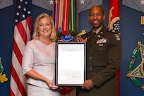 Secretary of the Army Christine Wormuth (left) presents the 62nd Annual Pace military award to Maj. Arthur Middlebrooks, Lead Program Analyst for Army Aviation platforms, modernization, enabling effects, and Special Access Programs, Headquarters Department of the Army, Deputy Chief of Staff, G-8, during a ceremony at the Pentagon, Arlington, Va., Sept. 5, 2024. The Pace award is based on performance and completion of significant staff assignments that benefit the Army by providing substantial financial savings, or technological or military development. (U.S. Army photo by Sgt. David Resnick)