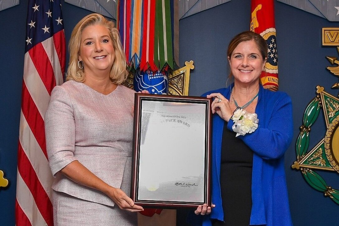 Secretary of the Army Christine Wormuth (left) presents the 62nd Annual Pace military award to Maj. Arthur Middlebrooks, Lead Program Analyst for Army Aviation platforms, modernization, enabling effects, and Special Access Programs, Headquarters Department of the Army, Deputy Chief of Staff, G-8, during a ceremony at the Pentagon, Arlington, Va., Sept. 5, 2024. The Pace award is based on performance and completion of significant staff assignments that benefit the Army by providing substantial financial savings, or technological or military development. (U.S. Army photo by Sgt. David Resnick)