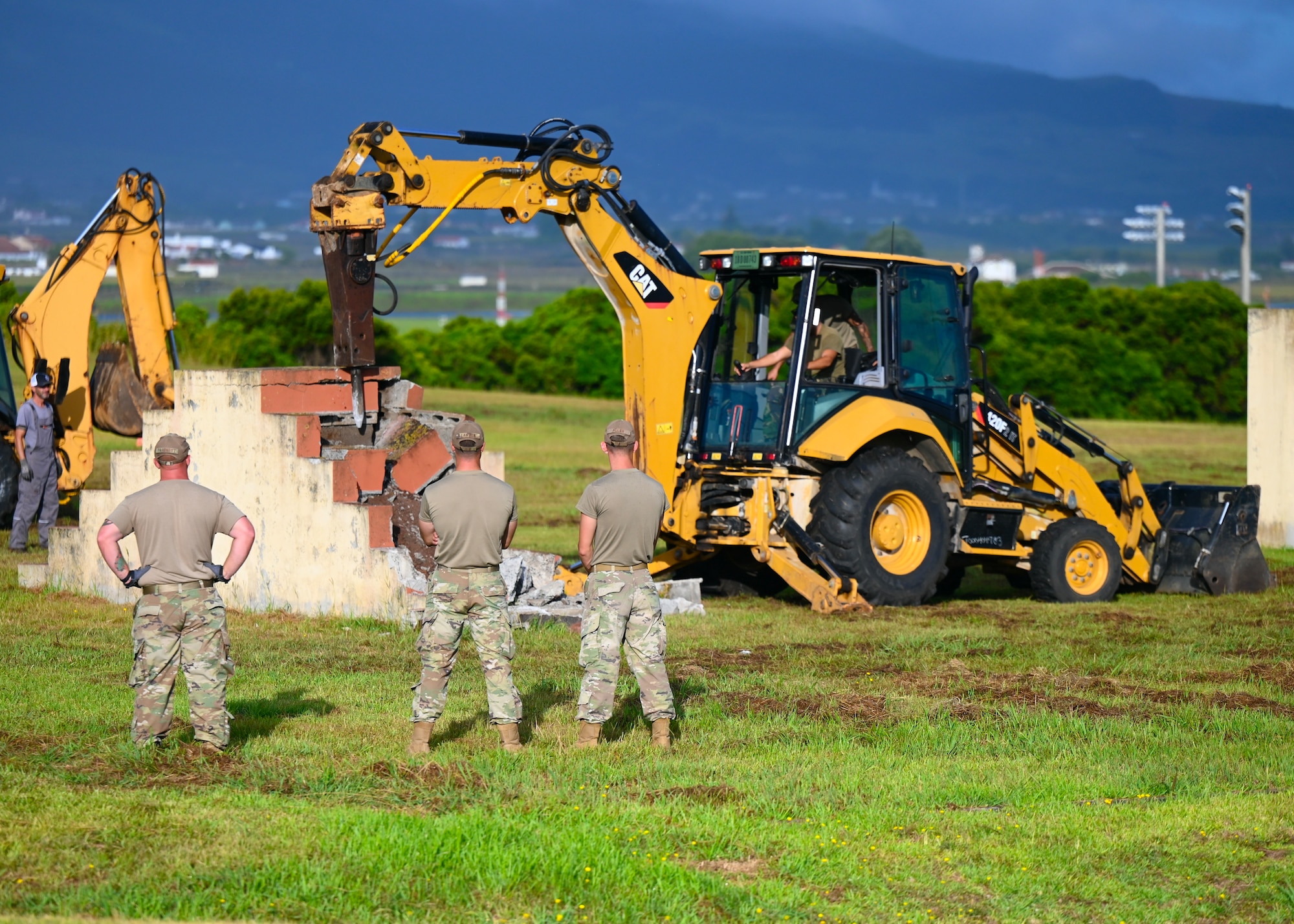 Members of the Civil Engineering Squadron monitor the demolition of concrete steps during a Deployment for Training (DFT) on Aug. 20, 2024. A DFT provides an opportunity to expand on an Airman’s skillset away from their home station, giving them a more diverse range of knowledge and making the squadron as a whole more versatile.(U.S. Air National Guard photo by Staff Sergeant Duane Morgan)