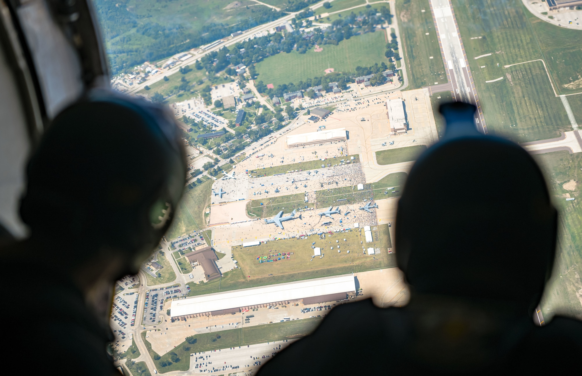 Soldiers of the U.S. Army Parachute Team, the Golden Knights, look out of the door of the C-147A jump aircraft prior to a parachute jump at the Defenders of Freedom Air and Space Show.