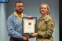 Col. Michelle M. Williams, U.S. Army Financial Management Command commander, presents a Maj. Gen. Nathan Towson Regimental Medallion to Waylon Vinson, USAFMCOM human resources specialist, at the Maj. Gen. Emmett J. Bean Federal Center in Indianapolis Sept. 4, 2024. The Towson was established by the U.S. Army Finance Corps Association on May 7, 1993, to recognize exceptional achievement or exemplary service by currently serving U.S. Army finance and comptroller commissioned officers, non-commissioned officers, enlisted Soldiers and civilians demonstrating exceptional leadership and whose accomplishments clearly distinguish them from their peers. (U.S. Army photo by Mark R. W. Orders-Woempner)