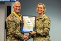 Col. Michelle M. Williams, U.S. Army Financial Management Command commander, presents a Maj. Gen. Nathan Towson Regimental Medallion to Col. Kevin D. Pierce, USAFMCOM chief of staff, at the Maj. Gen. Emmett J. Bean Federal Center in Indianapolis Sept. 4, 2024. The Towson was established by the U.S. Army Finance Corps Association on May 7, 1993, to recognize exceptional achievement or exemplary service by currently serving U.S. Army finance and comptroller commissioned officers, non-commissioned officers, enlisted Soldiers and civilians demonstrating exceptional leadership and whose accomplishments clearly distinguish them from their peers. (U.S. Army photo by Mark R. W. Orders-Woempner)