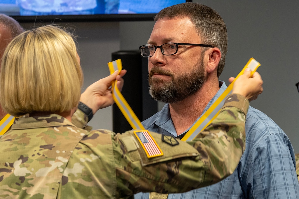 Col. Michelle M. Williams, U.S. Army Financial Management Command commander, presents a Maj. Gen. Nathan Towson Regimental Medallion to Waylon Vinson, USAFMCOM human resources specialist, at the Maj. Gen. Emmett J. Bean Federal Center in Indianapolis Sept. 4, 2024. The Towson was established by the U.S. Army Finance Corps Association on May 7, 1993, to recognize exceptional achievement or exemplary service by currently serving U.S. Army finance and comptroller commissioned officers, non-commissioned officers, enlisted Soldiers and civilians demonstrating exceptional leadership and whose accomplishments clearly distinguish them from their peers. (U.S. Army photo by Mark R. W. Orders-Woempner)