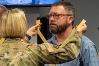 Col. Michelle M. Williams, U.S. Army Financial Management Command commander, presents a Maj. Gen. Nathan Towson Regimental Medallion to Waylon Vinson, USAFMCOM human resources specialist, at the Maj. Gen. Emmett J. Bean Federal Center in Indianapolis Sept. 4, 2024. The Towson was established by the U.S. Army Finance Corps Association on May 7, 1993, to recognize exceptional achievement or exemplary service by currently serving U.S. Army finance and comptroller commissioned officers, non-commissioned officers, enlisted Soldiers and civilians demonstrating exceptional leadership and whose accomplishments clearly distinguish them from their peers. (U.S. Army photo by Mark R. W. Orders-Woempner)