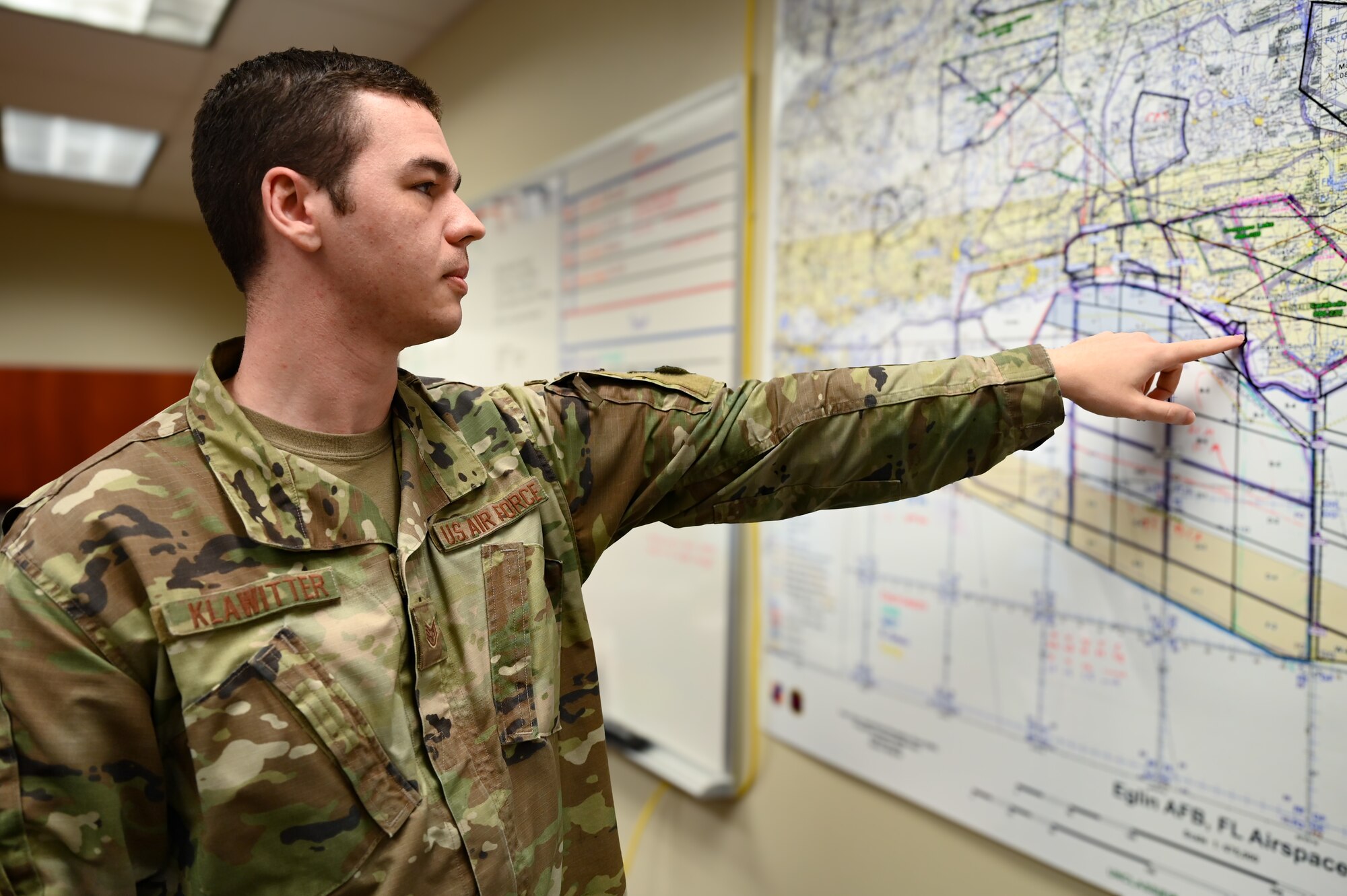 A photo of an Airman pointing.